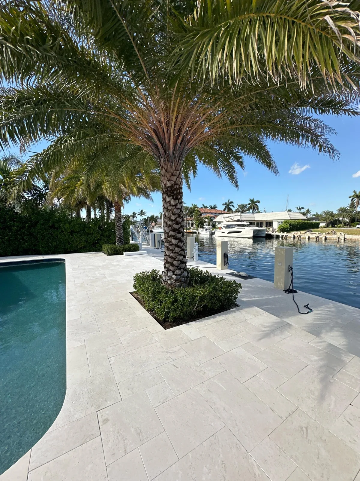 Manicured waterfront pool patio and landscaping on a Pompano Beach property