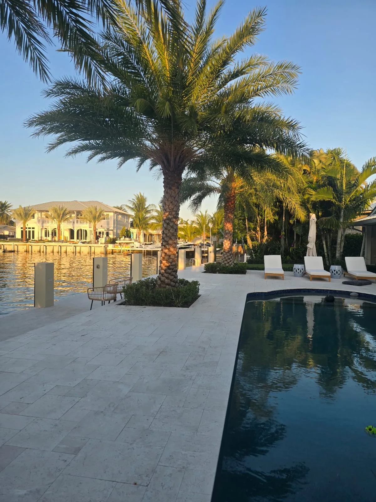 Waterfront lawn and pool at sunset in the Pompano Beach area